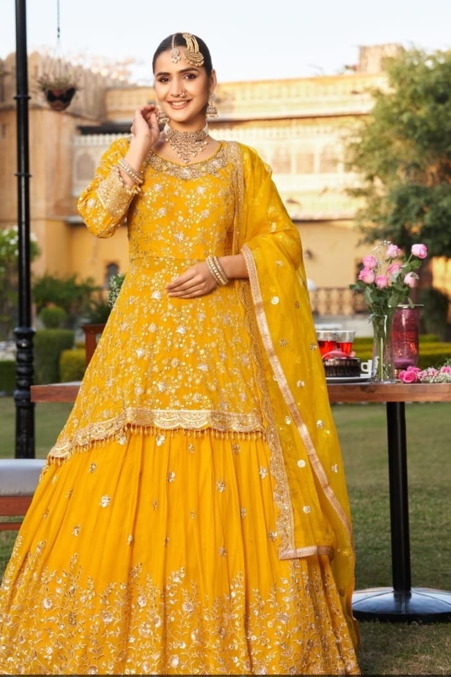 Probably georgette and organza over a silk .heavy floral thread embroidery with zari and sequins
